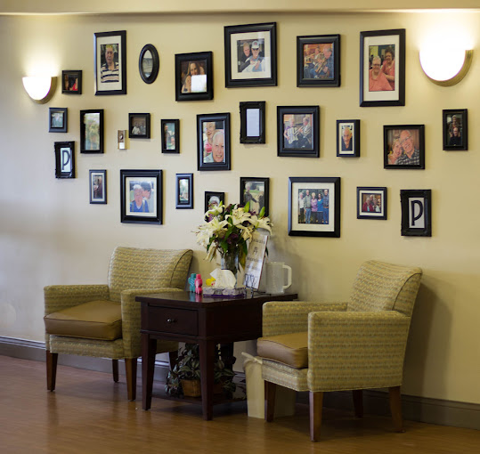 comfortable seating area and framed photos at Monument Health Pioneer Trail