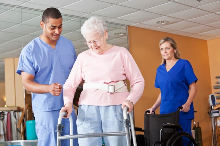 How Long Is A Short-Term Rehabilitation? 1 Two medical professionals helping a patient at a short-term rehab.