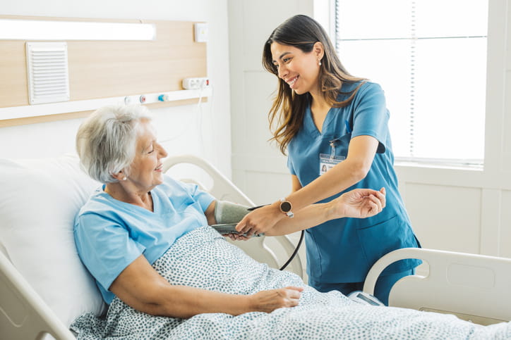 A nurse assisting a patient at a skilled nursing facility. 