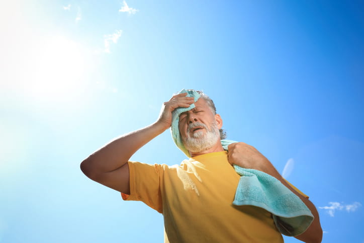Tips For Utah Seniors To Manage Chronic Conditions During The Summer Heat 1 An elderly man with a towel, sweating underneath the sun.