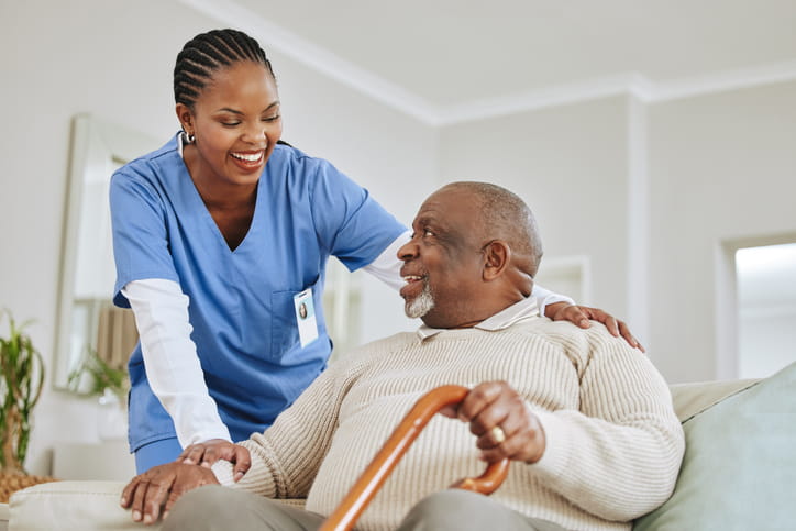 What Qualifies A Patient For Skilled Nursing Care? 1 A nurse smiling with a patient inside a skilled nursing facility.