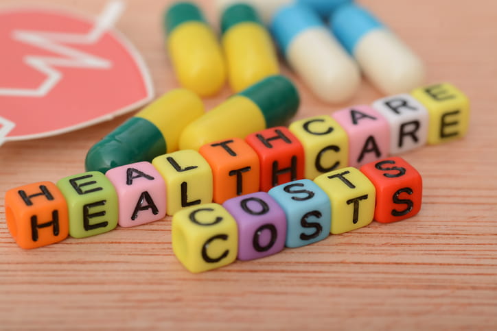 How Much Does A Skilled Nursing Facility Cost In Utah? 1 Colored blocks that spell out "Healthcare Costs" next to loose pills.