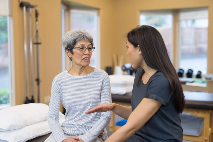 A senior speaks with a speech pathologist.