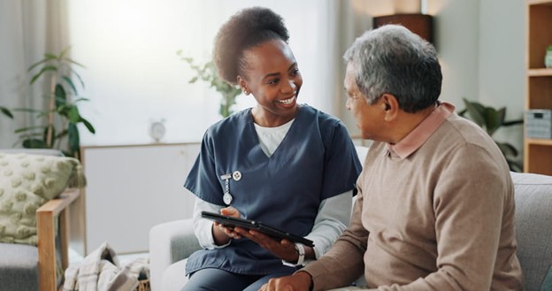 A nurse speaks with an elderly man after he moves into a skilled nursing facility.