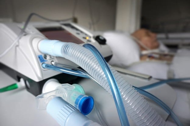 Ventilator Weaning And Rehabilitation: Understanding The Recovery Process 2 A closeup of a ventilator with a patient in the background.